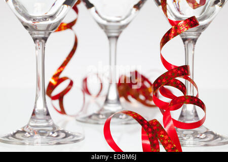 Three empty glasses on champagne and red ribbon Stock Photo