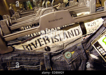 Jeans hanging, instore, River Island, London, England Stock Photo