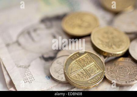 Illustrative image of a five pound note and various denomination sterling coins. Stock Photo