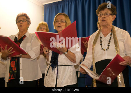 Women's Institute (WI) members singing at Christmas time in village hall, Whitehill, near Bordon, Hampshire, UK. Stock Photo