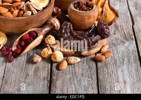 Mix of dried fruits and almonds - symbols of judaic holiday Tu Bishvat. Copyspace background. Stock Photo