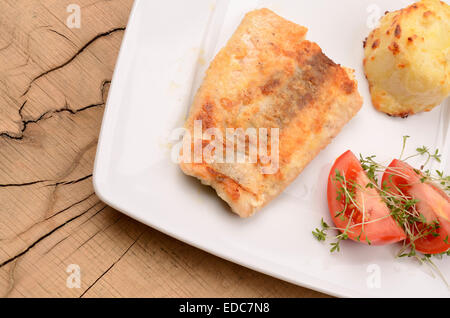 Wild salmon with fresh tomatoes and potato gratin Stock Photo