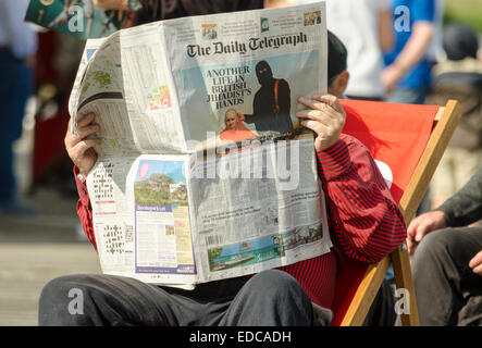 Man reading a newspaper on jihadist terrorist  [another life in there hands] UK Stock Photo