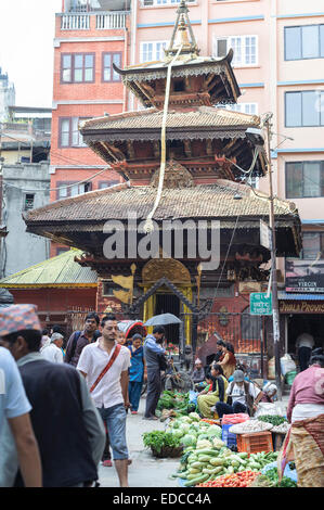 People are shopping a busy street named Ason Tole in front of the Ganesh Shrine, Indra Chowk, Kathmandu Nepal Stock Photo