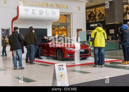 A Tesla Roadster Model S on display in the atrium of the Time Warner Center in New York on Sunday, January 4, 2015. Tesla is reported to have a 'snake-like' robotic charger in the works. The charge will emerge from the wall and automatically connect to your Model S Roadster. (© Richard B. Levine) Stock Photo