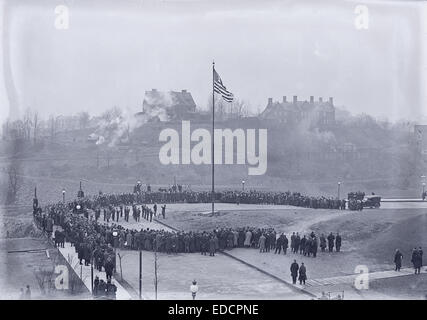 Antique circa 1915 photograph, groundbreaking ceremony for Langley Laboratory (current location of Hunt Library) at Carnegie Institute of Technology (now Carnegie Mellon University) in Pittsburgh, Pennsylvania, circa 1915. The Carnegie Institute of Technology Band plays for the flag raising. Note steam trains on track on hillside. The building on the hilltop at right is the old Mellon Mansion, torn down in the 1940s. Stock Photo