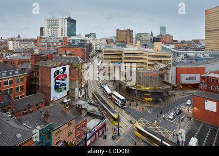 Manchester High Street in the Shudehill area of the city centre, a Metrolink tram stops at lights, Stock Photo