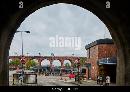 Stockport town centre's viaduct framed by an arch from the main A6 road, with the bus station in the foreground Stock Photo