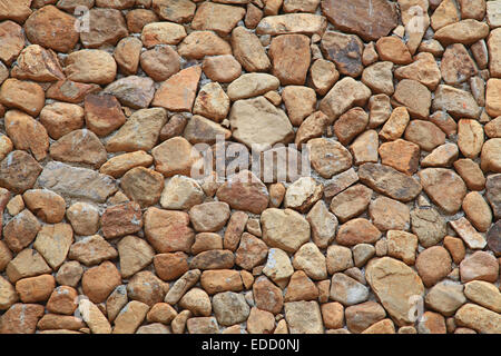 Traditional Stone Brick Wall made of fragment stones in irregular shapes Stock Photo