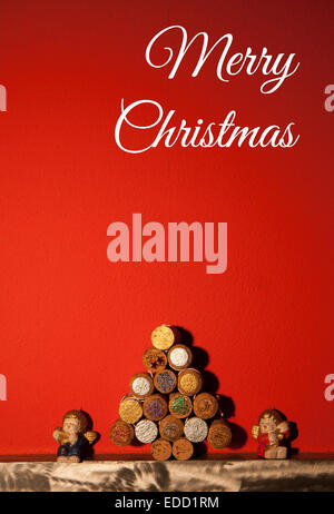 christmas tree cork with two little angels on orange background Stock Photo
