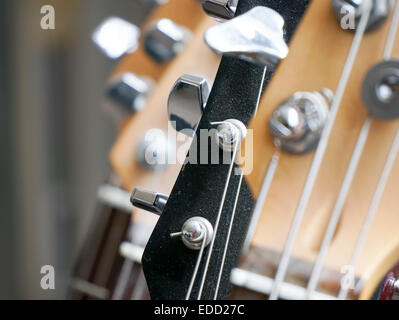 Guitars on rack with bass and electric guitar Stock Photo