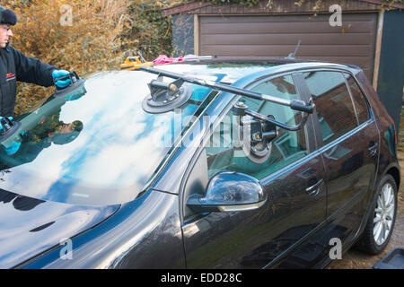 A technician for Autoglass fitting a new windscreen Stock Photo