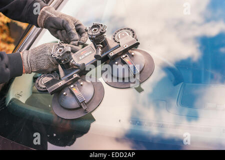 A technician for Autoglass fitting a new windscreen Stock Photo