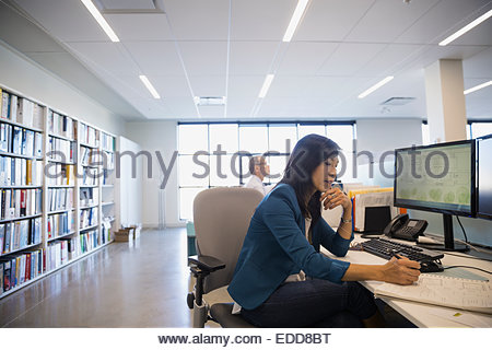 Architect drafting plans at desk in office