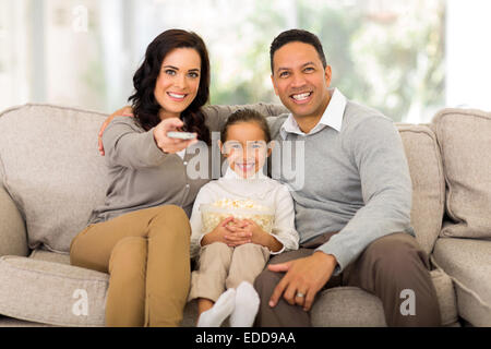 young family watching tv in the living room at home Stock Photo