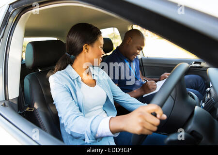 beautiful African girl taking driving lessons Stock Photo