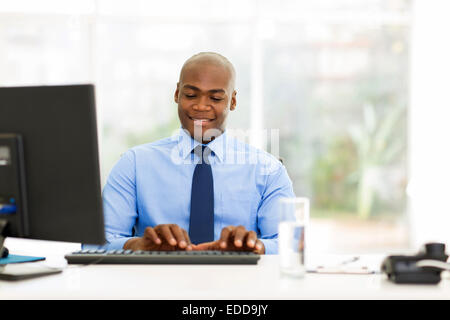 handsome young African businessman working in office Stock Photo