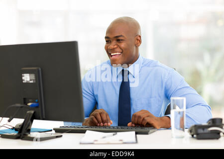 cheerful African American businessman working on computer Stock Photo