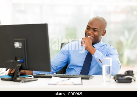 happy young African businessman working on computer Stock Photo
