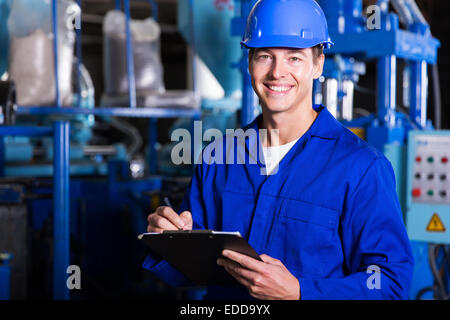 male industrial technician working inside a factory Stock Photo