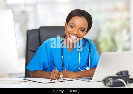 happy young African female nurse working in office Stock Photo