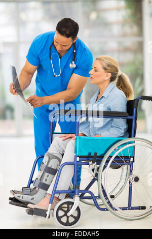 doctor explaining x-ray results to patient in wheelchair Stock Photo