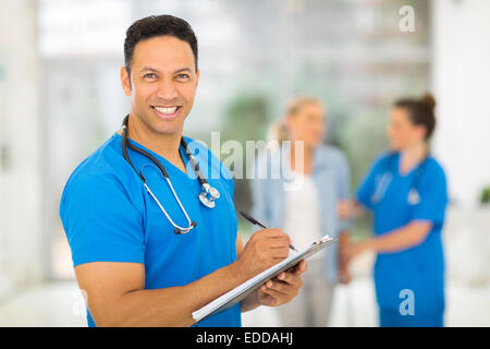 happy middle aged medical doctor writing prescription Stock Photo