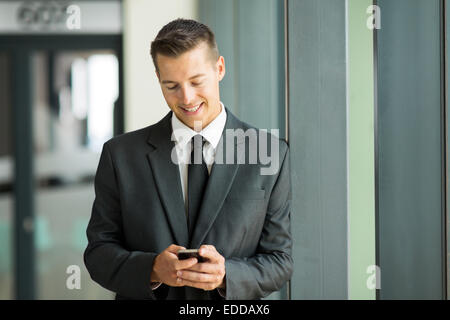 happy businessman texting on his smart phone Stock Photo