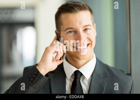 good looking business executive talking on mobile phone Stock Photo