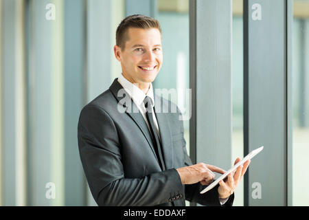 portrait of happy businessman using tablet computer Stock Photo