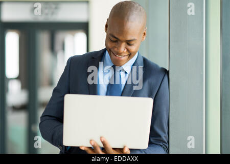 African American businessman working on laptop in modern office Stock Photo