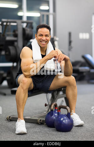 happy mid age man sitting on bench after exercise Stock Photo