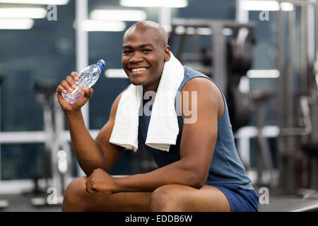 happy young African man drinking water after exercise Stock Photo