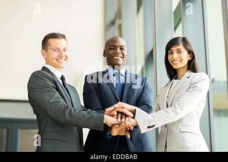 happy multiracial business team putting hands together Stock Photo