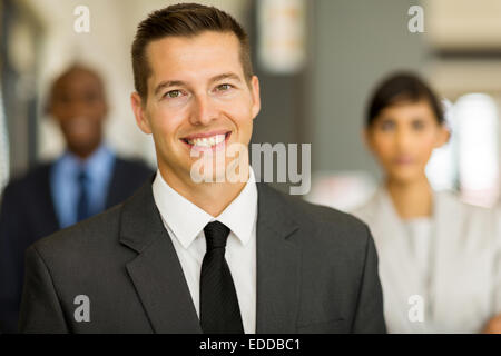 good looking young business man with colleagues on background Stock Photo