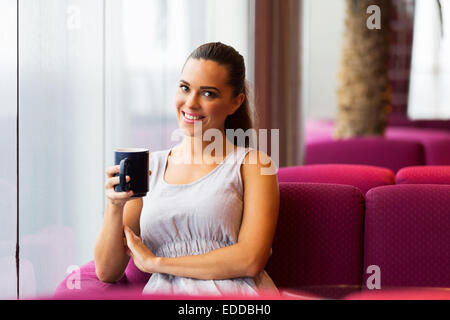 cheerful young woman drinking coffee Stock Photo