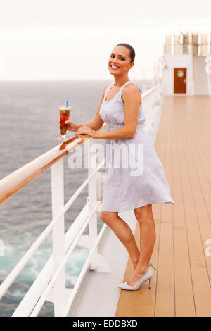 beautiful woman holding glass of cocktail on cruise ship Stock Photo