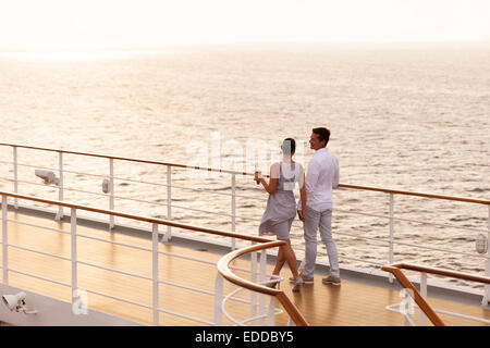 cute couple walking on cruise ship deck at sunset Stock Photo