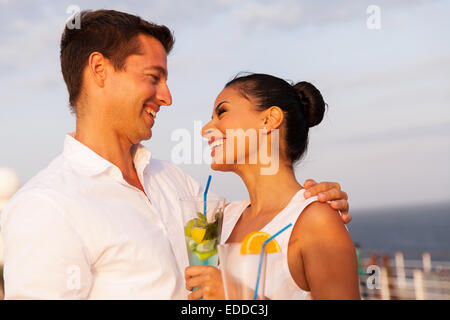 romantic young couple on cruise having cocktails Stock Photo