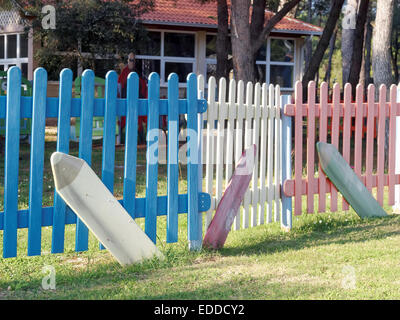 children playground surrounded with wooden colored fence Stock Photo