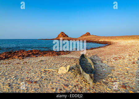 Little canoe on the rocky beach, Dihamri, island of Socotra, Yemen Stock Photo