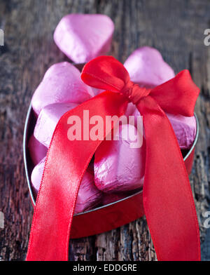 red hearts and chocolate candy on a table Stock Photo