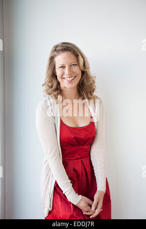 https://l450v.alamy.com/450v/eddj7r/portrait-of-smiling-mature-woman-wearing-red-dress-eddj7r.jpg