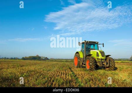 A tractor in a stubble field in Gloucestershire. Stock Photo