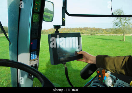 Technical equipment aboard a tractor, a hand touching a touch screen. Stock Photo