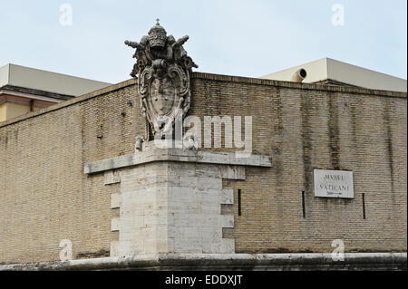 A papal sculpture on the wall surrounding the Pope residence in Vatican City, Rome, Italy. Stock Photo