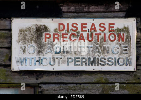 Sign on a Suffolk farm building saying 'Disease Precaution No Admittance Without Permission' Stock Photo