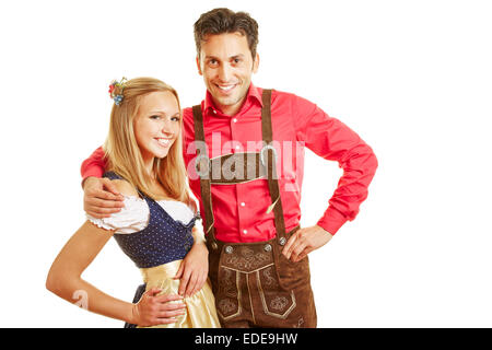 Happy smiling couple in traditional bavarian outfit with dirndl dress and leather pants Stock Photo