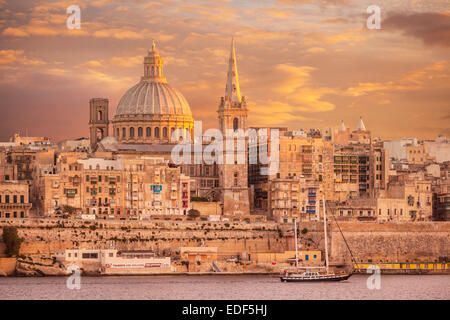 Valletta Skyline at Sunset with the Dome of the Carmelite Church and St Pauls Anglican Cathedral Valletta Malta EU Europe Stock Photo