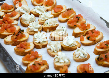 Delicious appetizer canapes with bread, salmon and cheese cream. Selective Focus Stock Photo